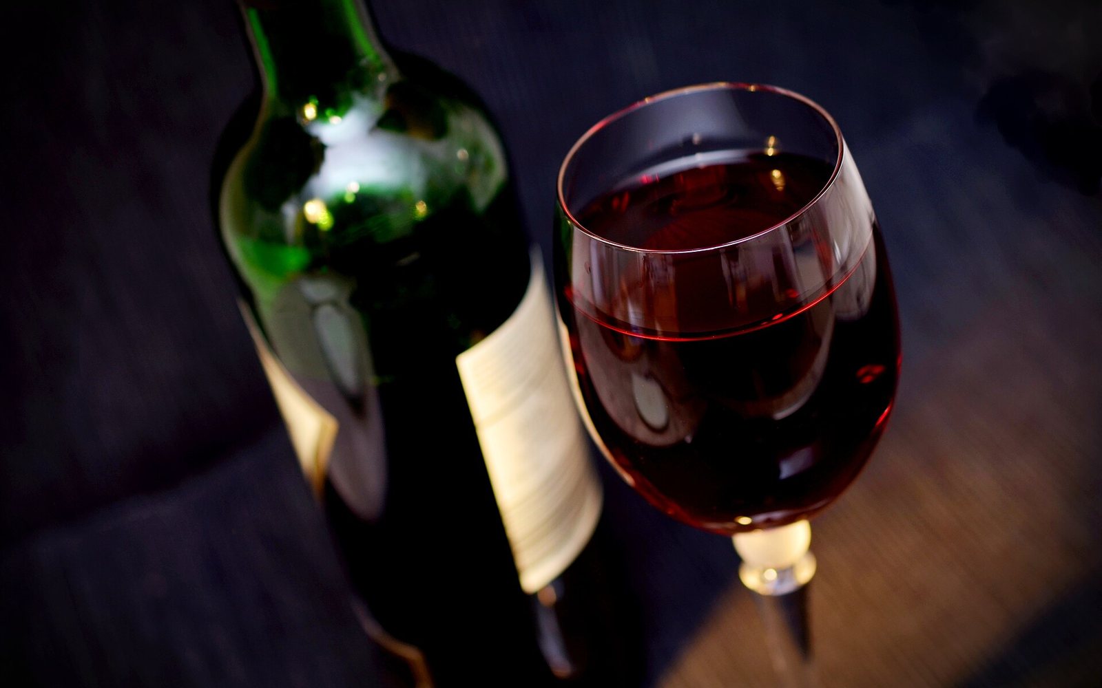 A bottle and glass of red wine