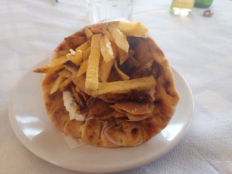 Greek gyro pita in Nafplio: thick pita stuffed with sliced spit meat, tzatziki and fries