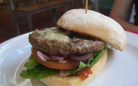 A Simply Grill'd beef burger with lettuce, tomato and onion, served at a Grill'd restaurant