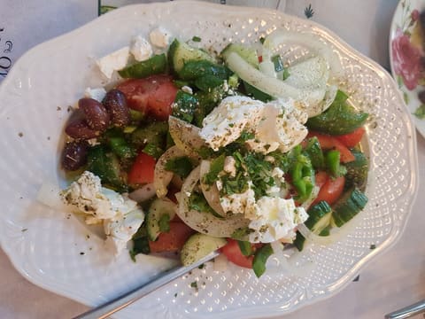 Horiatiki Greek salad from Thessaloniki with tomato, cucumber, onion, feta chunks, Kalamata olives and oregano