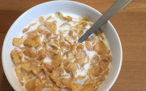 A bowl of Kellogg's Corn Flakes with milk