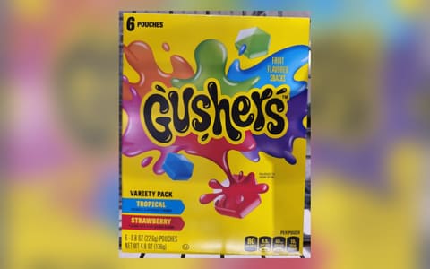A box of Gushers fruit flavored snacks, Tropical and Strawberry variety pack, 6 pouches