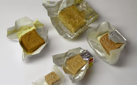 Unwrapped stock cubes in their foil wrappers