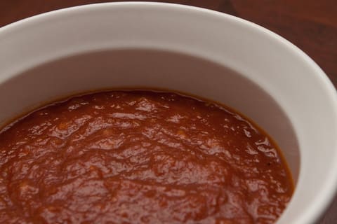 Barbecue sauce in a plain white bowl (product-neutral)