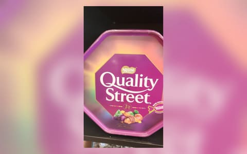 A Quality Street tub on a shop shelf