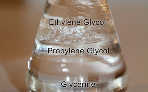 A flask of clear liquids in labelled layers: ethylene glycol, propylene glycol and glycerine
