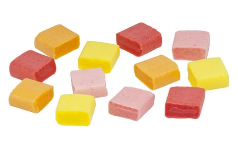 Unwrapped Starburst fruit chews in red, pink, orange and yellow
