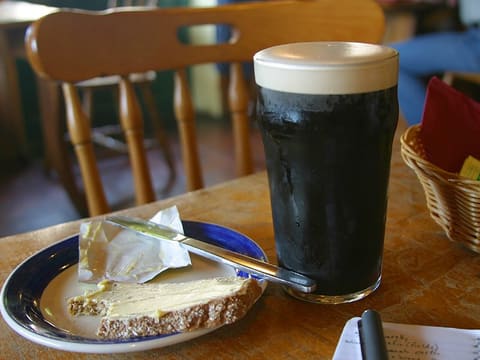 Dark stout beer in a glass (product-neutral; not an official Guinness photo)