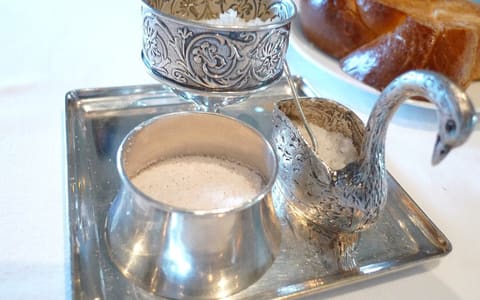 Coarse salt in silver salt cellars on a tray