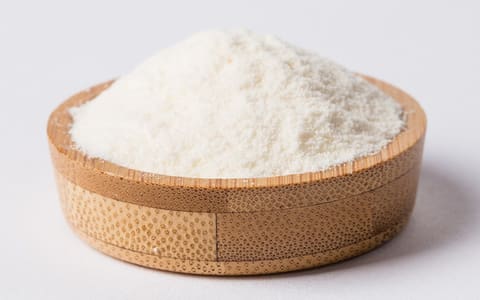 White polydextrose powder in a wooden bowl