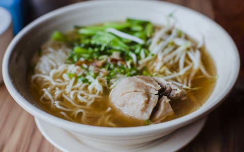 A bowl of Indonesian bakso: meatballs in broth with noodles and bean sprouts