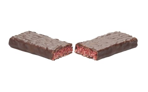 A Cherry Ripe bar split in half, showing the red cherry-and-coconut centre under dark chocolate
