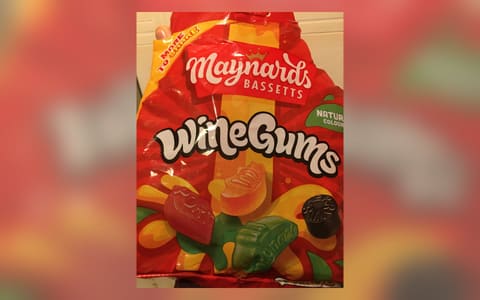 A bag of Maynards Bassetts Wine Gums held in a hand