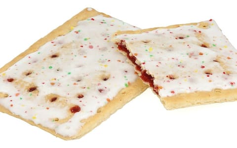 Two frosted strawberry Pop-Tarts, one broken to show the filling