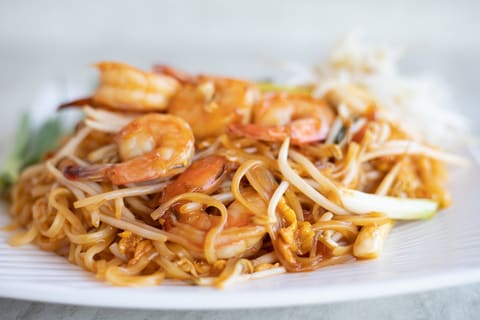 A plate of pad Thai noodles