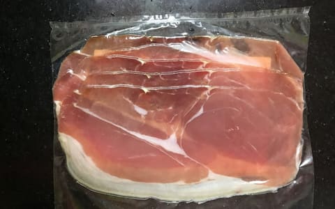 Thin slices of Parma prosciutto in a vacuum pack